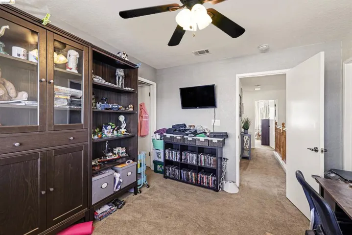 Office featuring light colored carpet and a ceiling fan