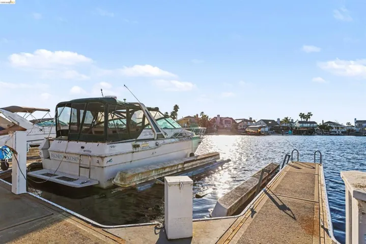 Dock area with a water view and a residential view