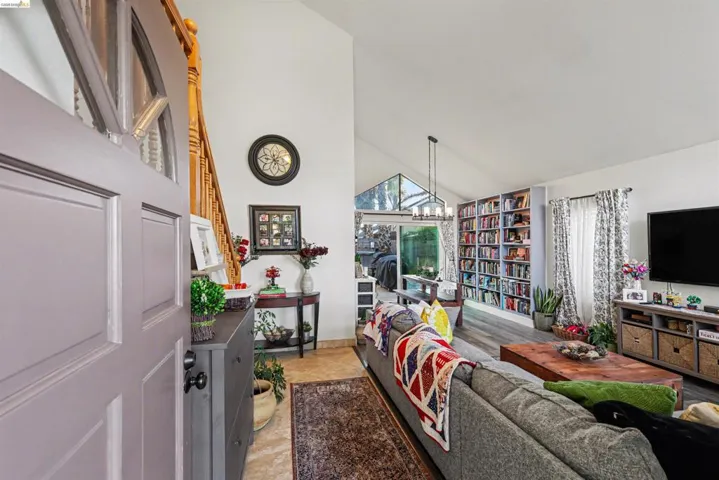Living room with vaulted ceiling and baseboards