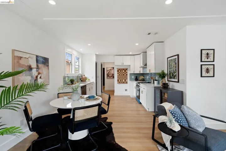 Dining area with light wood-style floors and recessed lighting