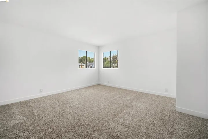Empty room with carpet and baseboards