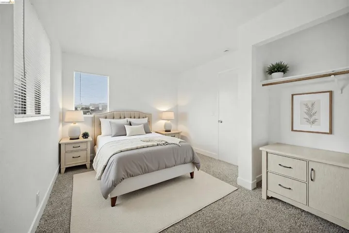 Bedroom with baseboards and light carpet