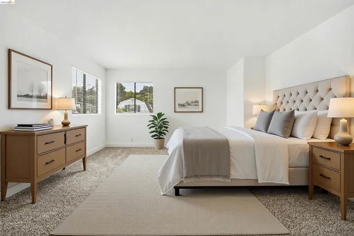 Bedroom with light colored carpet and baseboards