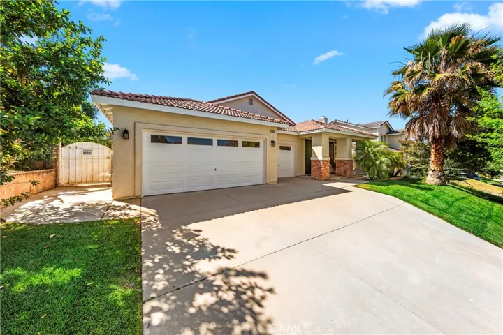 Wide driveway with plenty of parking for multiple vehicles and easy access to the garage..