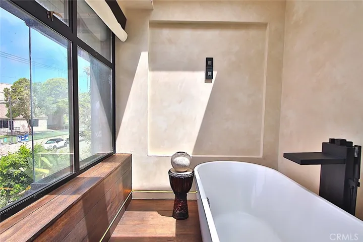 Separate area for a soaking tub in the primary bathroom.
