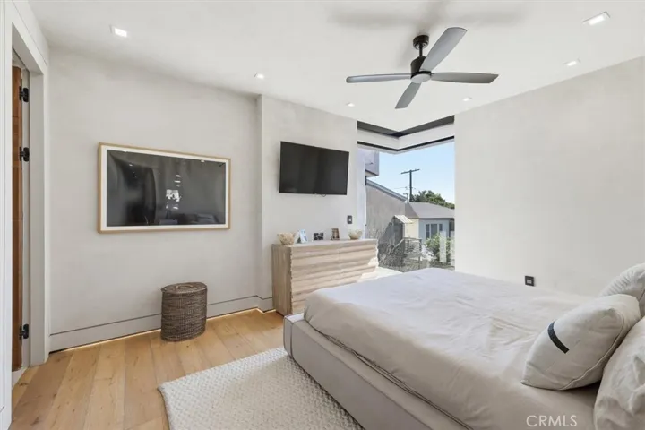 Second bedroom with ensuite bathroom , walk in closet, and corner sliding doors that leads to a private patio area.