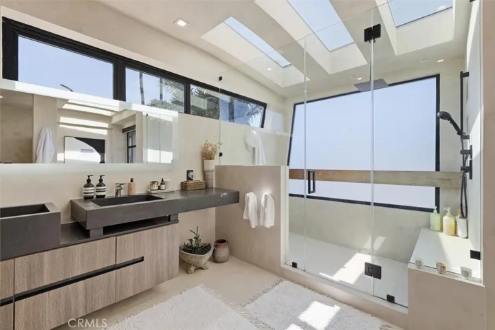 Second bedroom with ensuite bathroom , walk-in closet , and  corner sliding doors that go to a private patio area.