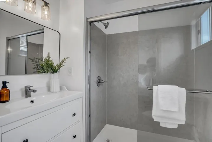 Full bath with vanity and a shower stall