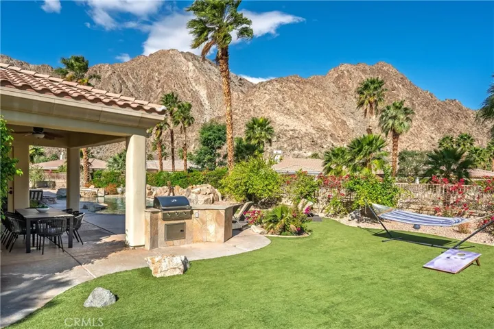 A versatile backyard setting perfect for cornhole, sunning, or casual gatherings.