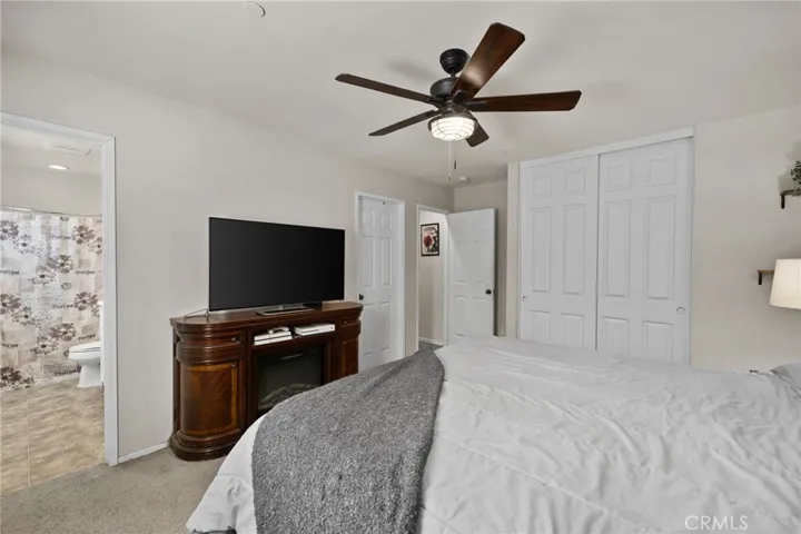 Primary suite offers plenty of storage space with both a traditional reach-in closet and a spacious walk-in closet