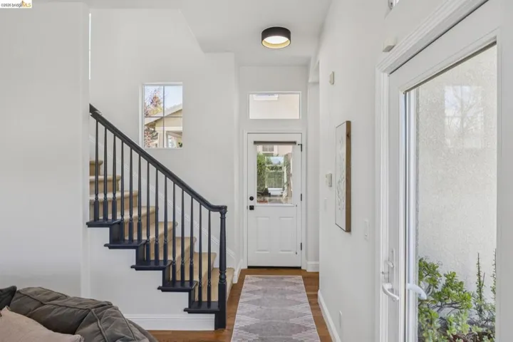 Entryway with wood finished floors and stairway