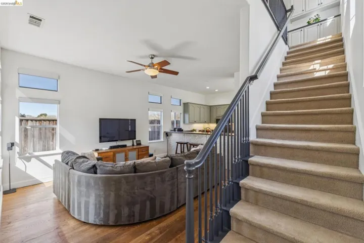 Living room featuring a ceiling fan, recessed lighting, and wood finished floors