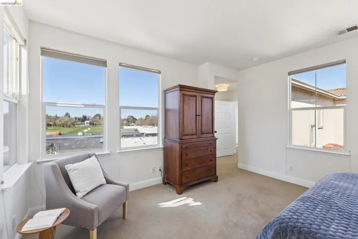 Bedroom featuring light carpet and baseboards