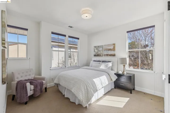 Bedroom featuring light colored carpet