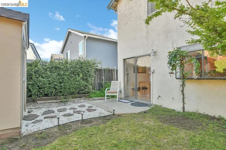 Rear view of property featuring a patio and stucco siding