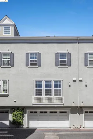 View of building exterior featuring a garage and driveway