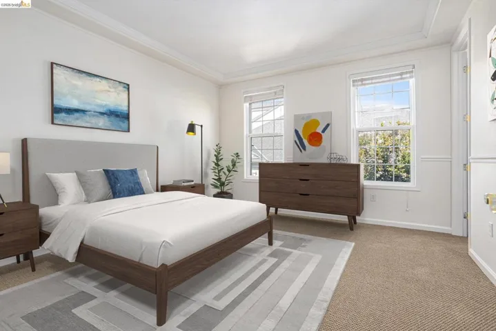 Bedroom with light carpet and ornamental molding