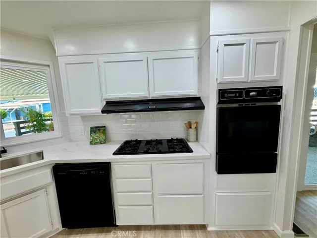 Love the black appliances with the white cabinets