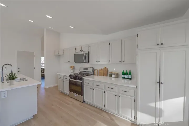 Remodeled Kitchen (Disclaimer: Some images have been digitally enhanced with virtual staging to illustrate potential room layouts and furnishings. Actual property condition and features may vary. Buyer to verify all information independently).