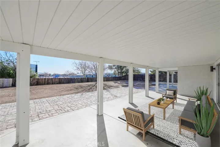 Covered Patio (Disclaimer: Some images have been digitally enhanced with virtual staging to illustrate potential room layouts and furnishings. Actual property condition and features may vary. Buyer to verify all information independently).