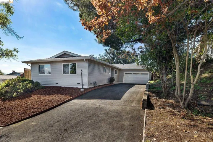 Ranch-style home with asphalt driveway, a garage, and crawl space