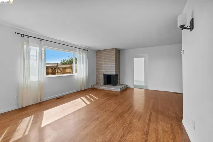 Unfurnished living room featuring light wood finished floors and a fireplace