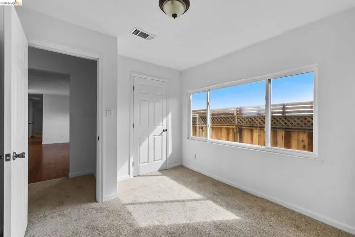Unfurnished bedroom featuring light carpet and a closet