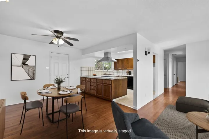 Dining area with wood finished floors and a ceiling fan