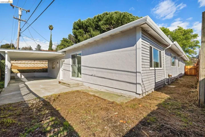 View of side of home featuring stucco siding