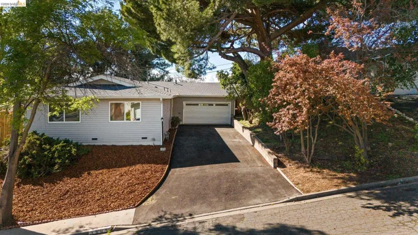 Single story home with crawl space, a garage, driveway, and a shingled roof