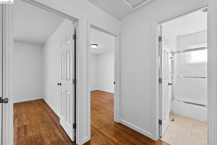 Corridor with baseboards and light wood-style floors