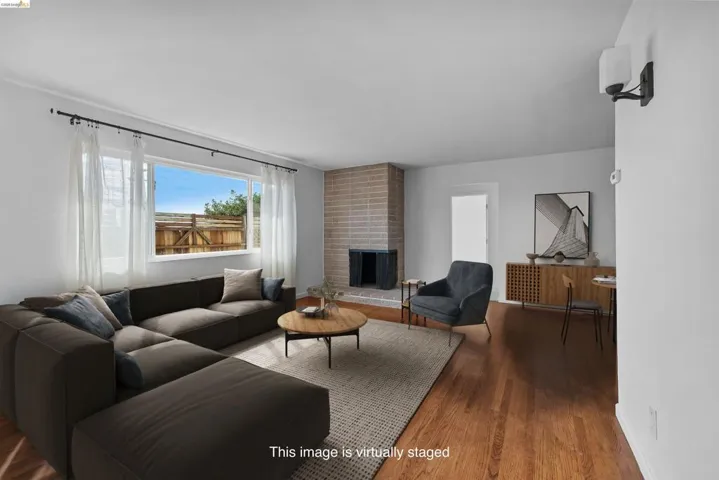 Living area featuring wood finished floors and a brick fireplace