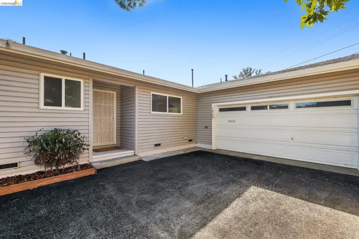 Single story home featuring driveway, crawl space, and a garage