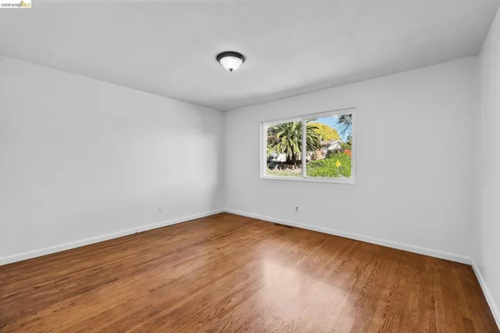 Empty room with wood finished floors and baseboards