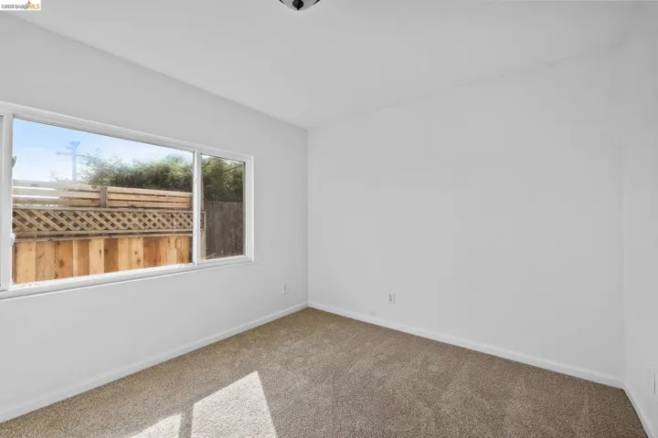 Unfurnished room with baseboards and carpet flooring