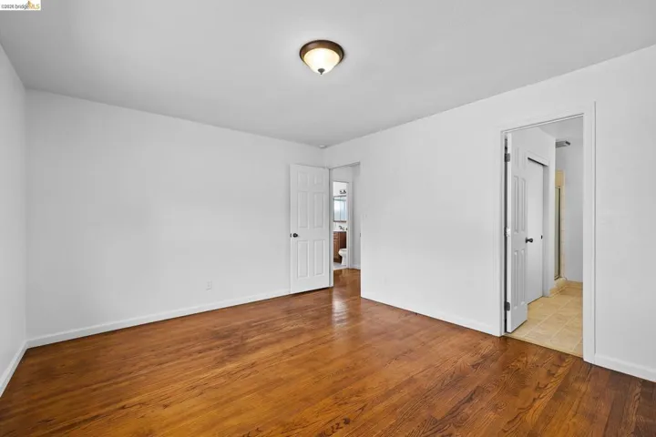 Empty room with light wood-style flooring and baseboards