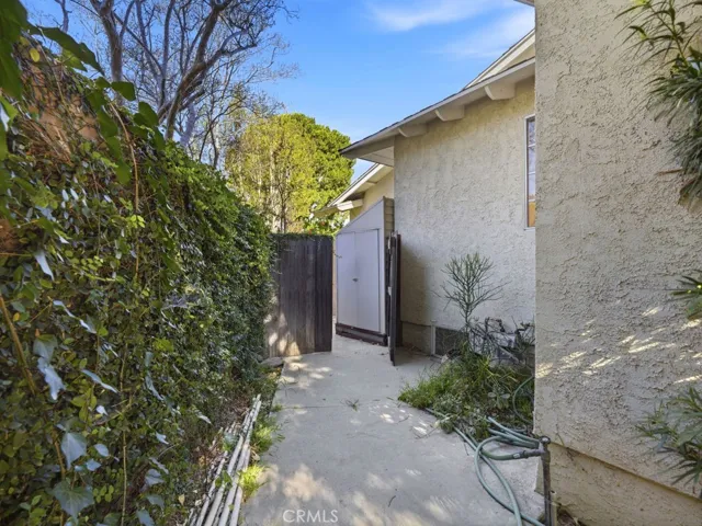 storage shed on the other side of the house that is hidden behind a gate