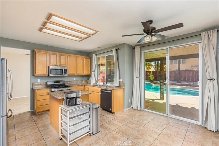 Portion of kitchen looking out to pool.  Granite counters. Stainless steel appliances. Walk in pantry.