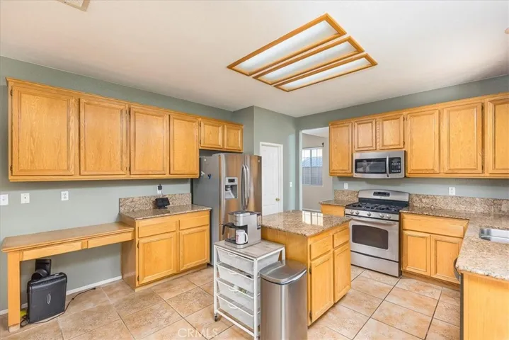 Other side of kitchen with pantry and door into dining area.