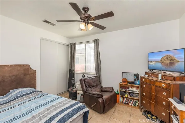 Downstairs bedroom with ceiling fan.