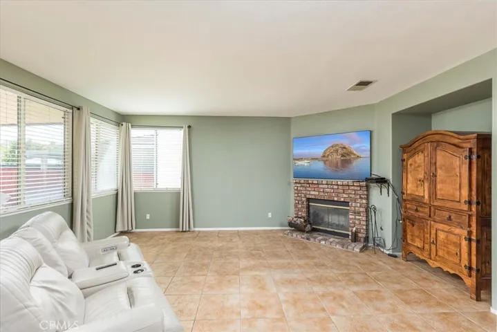 Family room with numerous windows and fireplace.