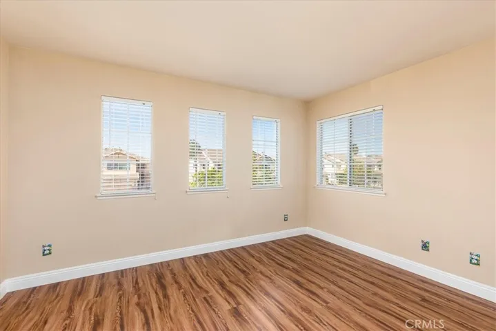 Upstairs bedroom with numerous windows.