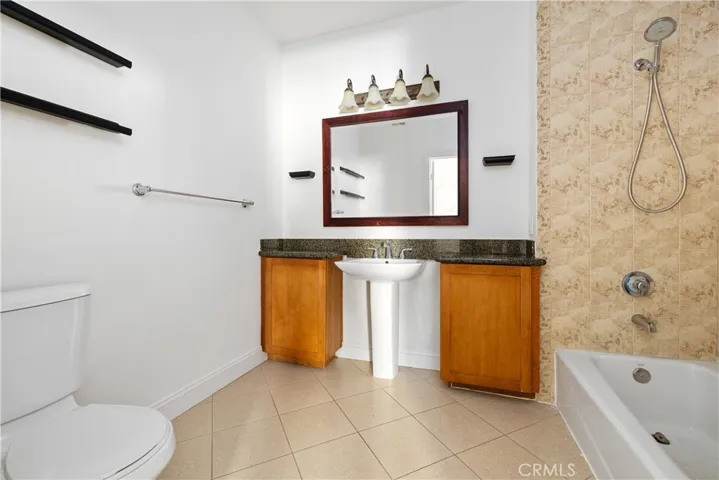 Primary full bathroom with pedestal sink and seoarating counters