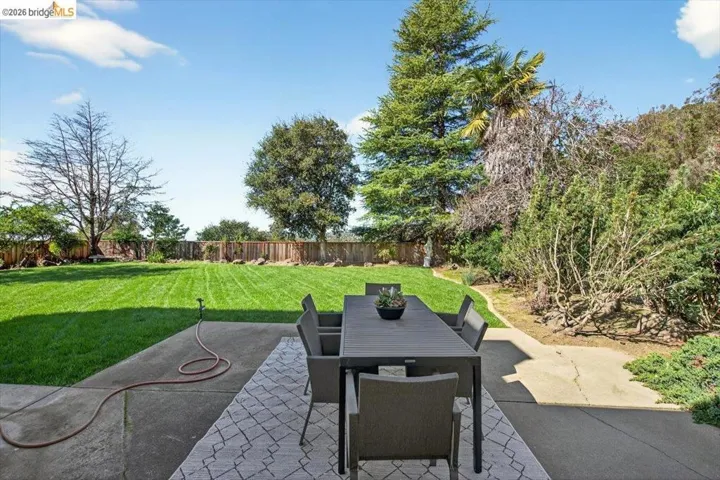 Fenced backyard featuring a patio area and outdoor dining area