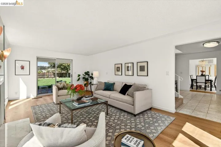 Living room featuring light wood-type flooring and a textured ceiling