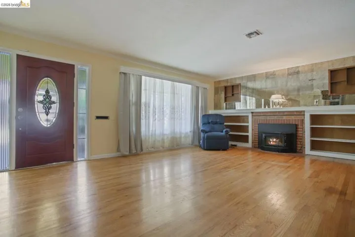 Foyer featuring light wood finished floors and crown molding