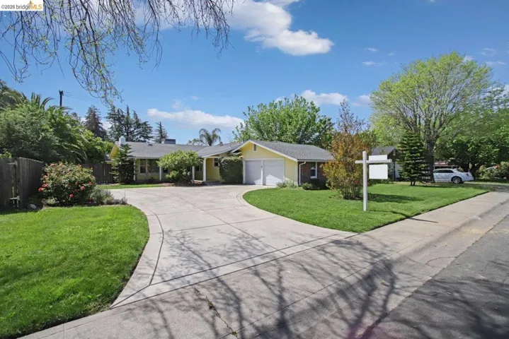 Ranch-style home with driveway and an attached garage
