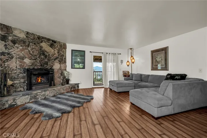 Cozy stone fireplace and solid surface floors.