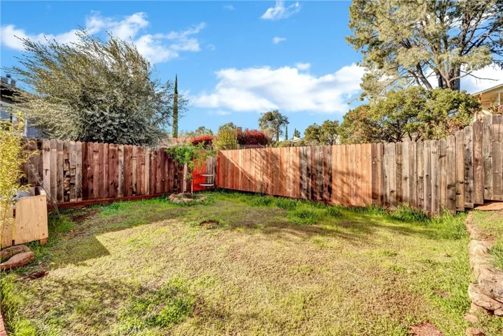 Fenced yard with fruit trees.