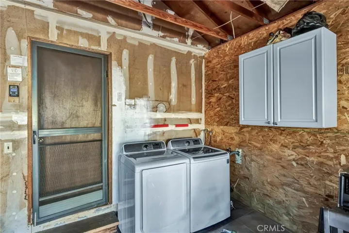Laundry area located inside the garage for convenience.